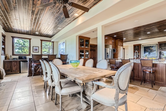 dining area featuring wood ceiling, light tile patterned flooring, and ceiling fan