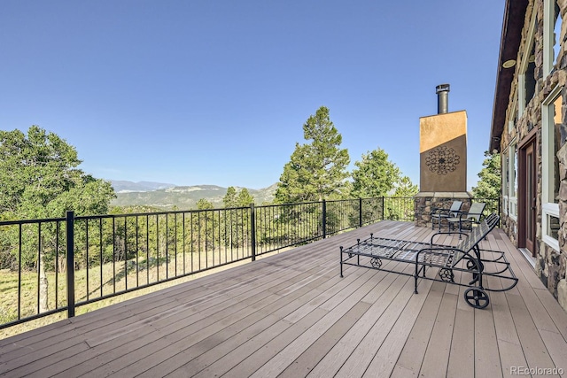 wooden deck with a mountain view