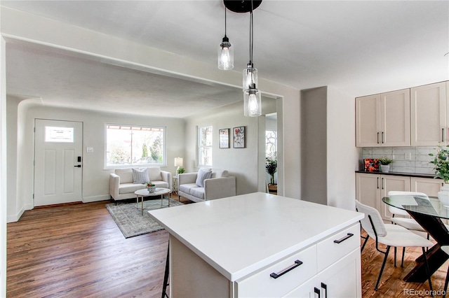 6220 W 11th Pl, Lakewood, CO 80214 - kitchen with wood finished floors, plenty of natural light, open floor plan, and decorative light fixtures