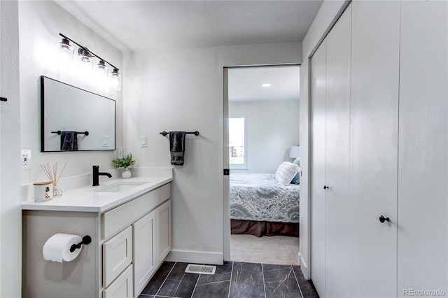 6220 W 11th Pl, Lakewood, CO 80214 - ensuite bathroom with vanity and marble look tile flooring