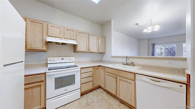 kitchen with under cabinet range hood, a sink, light brown cabinets, and white appliances