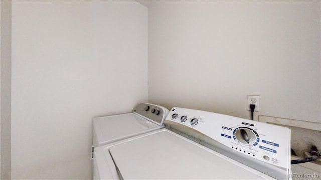 clothes washing area with independent washer and dryer