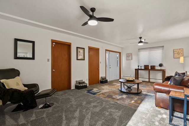 living room with ceiling fan and carpet