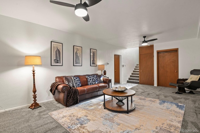 carpeted living room with ceiling fan