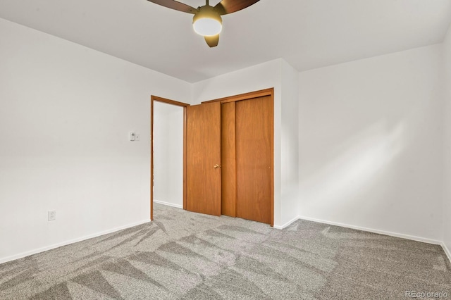 unfurnished bedroom featuring ceiling fan, a closet, and carpet floors