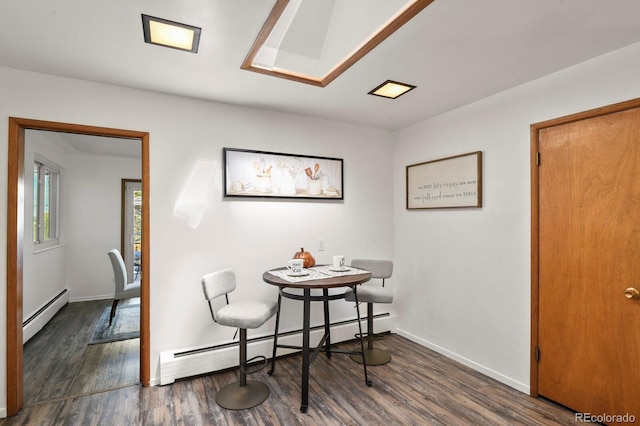 dining room featuring dark hardwood / wood-style flooring and a baseboard heating unit