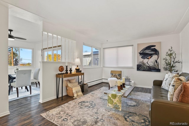 living room with ceiling fan, dark hardwood / wood-style flooring, and a baseboard heating unit