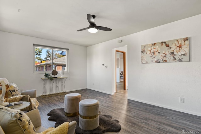 sitting room with ceiling fan and dark hardwood / wood-style floors