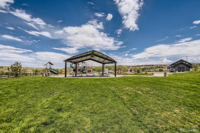 view of home's community with playground community and a yard