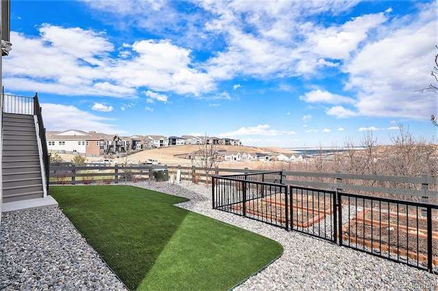 view of yard with a residential view and fence