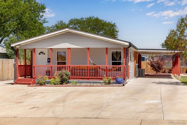 1214 Mac Kay Ct, Dacono, CO 80514 - view of front facade with covered porch, concrete driveway, and an attached carport
