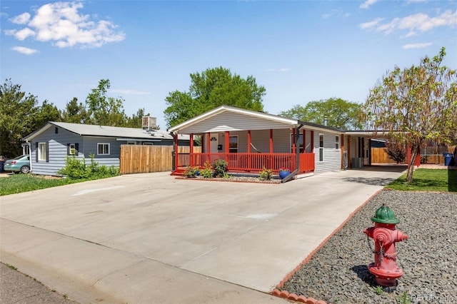 1214 Mac Kay Ct, Dacono, CO 80514 - view of front of home with covered porch, driveway, and a carport