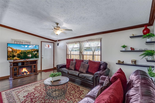 1214 Mac Kay Ct, Dacono, CO 80514 - living area featuring a ceiling fan, wood finished floors, a glass covered fireplace, a textured ceiling, and ornamental molding