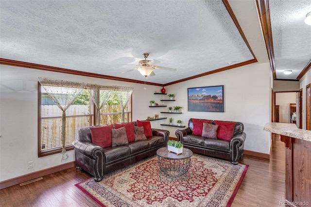 1214 Mac Kay Ct, Dacono, CO 80514 - living area featuring a textured ceiling, a ceiling fan, wood finished floors, crown molding, and lofted ceiling