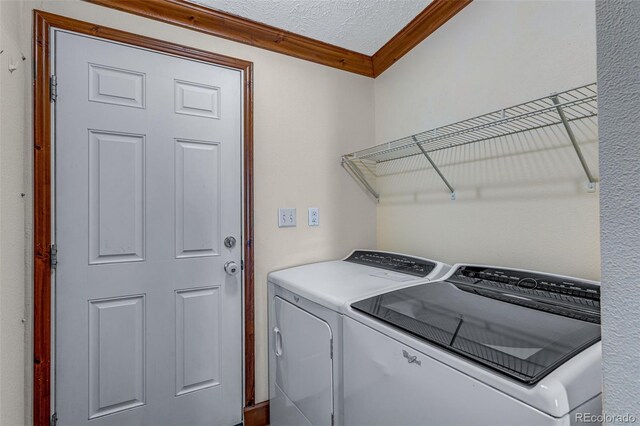 1214 Mac Kay Ct, Dacono, CO 80514 - washroom with washing machine and dryer, ornamental molding, and a textured ceiling