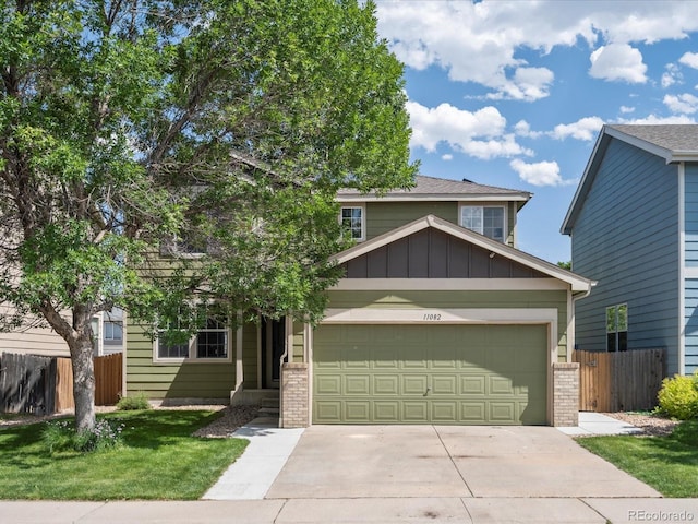 11082 Fillmore Way, Northglenn, CO 80233 - view of front of home with driveway, a garage, brick siding, and board and batten siding