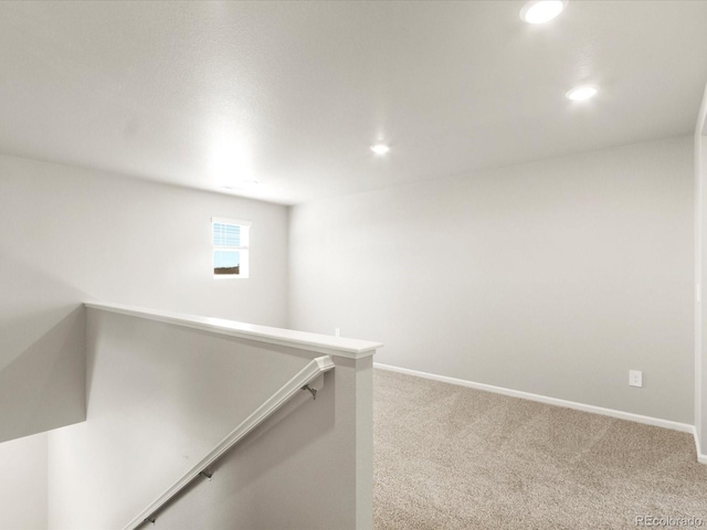 hallway featuring an upstairs landing, carpet flooring, recessed lighting, and baseboards