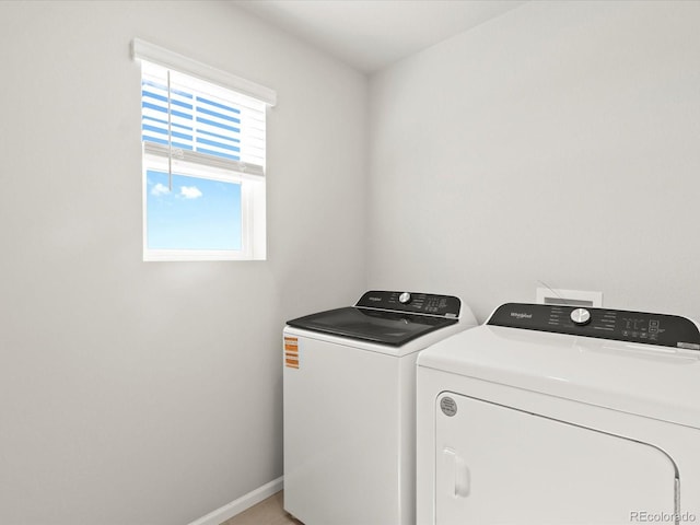 laundry room with laundry area, baseboards, and separate washer and dryer