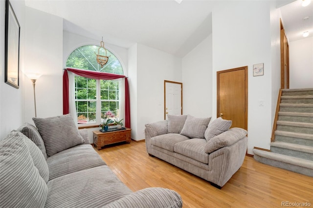 7796 Xavier Ct, Westminster, CO 80030 - living area with high vaulted ceiling, light wood-style floors, and stairway