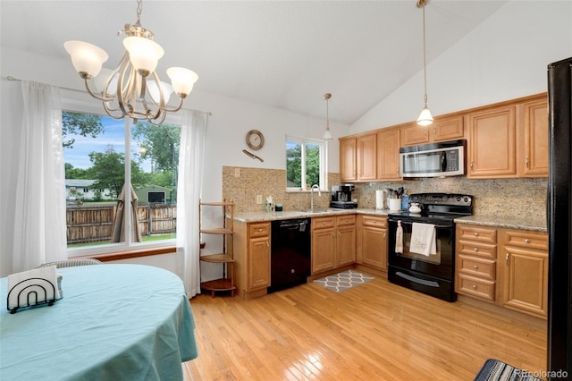 7796 Xavier Ct, Westminster, CO 80030 - kitchen featuring black appliances, decorative backsplash, a chandelier, light wood-style floors, and hanging light fixtures