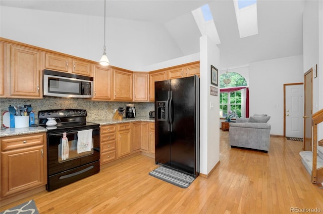 7796 Xavier Ct, Westminster, CO 80030 - kitchen featuring black appliances, a skylight, high vaulted ceiling, backsplash, and light wood-style flooring