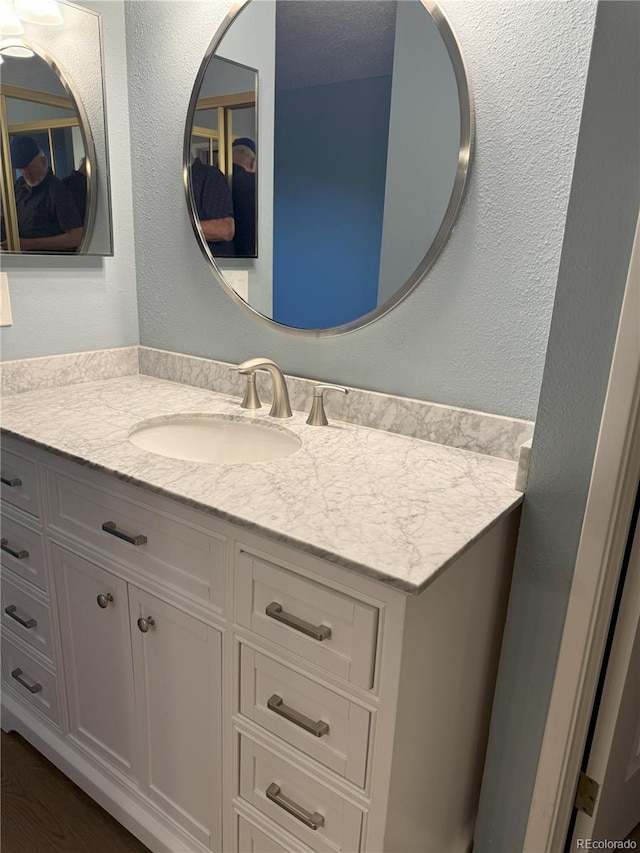 bathroom with vanity and hardwood / wood-style floors