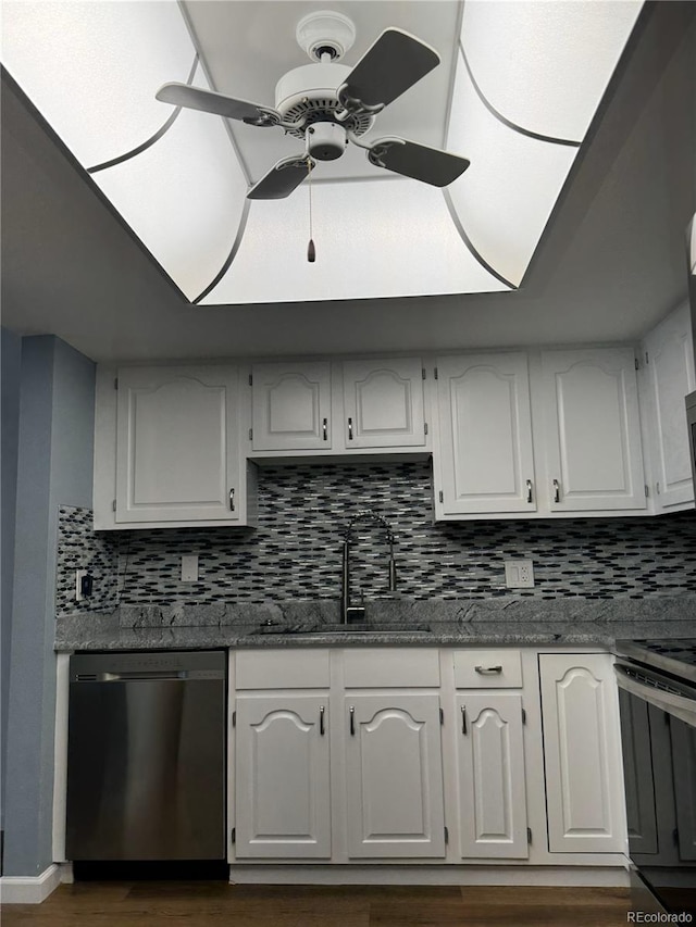 kitchen with tasteful backsplash, stainless steel appliances, sink, white cabinetry, and ceiling fan