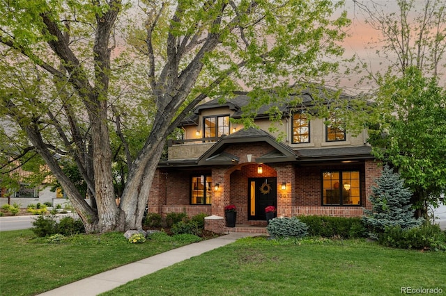 301 Fairfax St, Denver, CO 80220 - view of front of property with covered porch, brick siding, a lawn, and a balcony