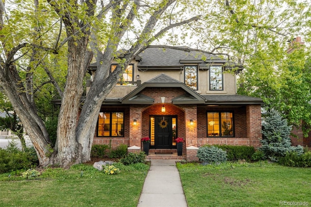 301 Fairfax St, Denver, CO 80220 - view of front of house with a front lawn, a porch, stucco siding, and brick siding