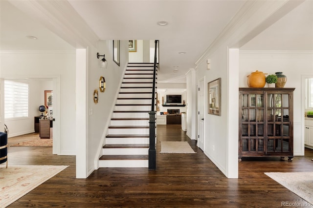 301 Fairfax St, Denver, CO 80220 - stairway featuring wood finished floors, crown molding, and baseboards