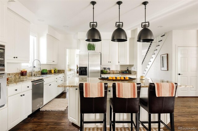 301 Fairfax St, Denver, CO 80220 - kitchen featuring appliances with stainless steel finishes, a sink, dark wood-type flooring, white cabinets, and recessed lighting