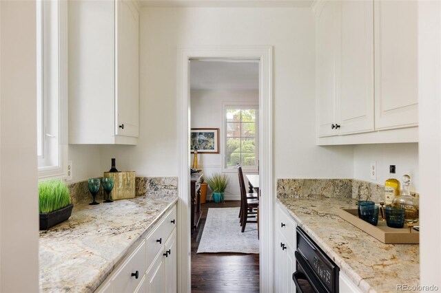 301 Fairfax St, Denver, CO 80220 - kitchen with dark wood-style flooring, white cabinets, and light stone counters