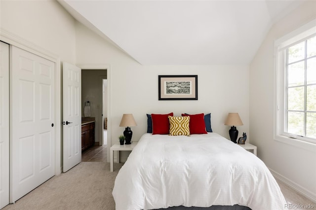 301 Fairfax St, Denver, CO 80220 - bedroom with lofted ceiling, light colored carpet, ensuite bath, baseboards, and a closet