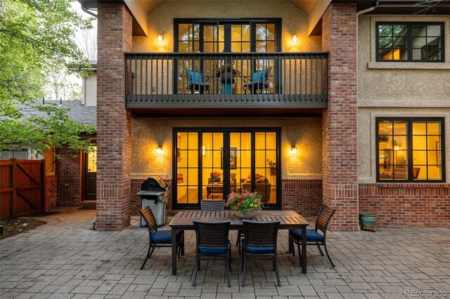 301 Fairfax St, Denver, CO 80220 - back of property featuring a balcony, stucco siding, a patio, and fence
