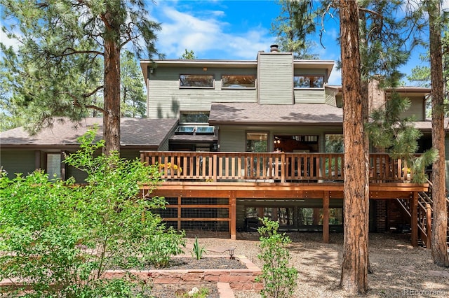 4515 Red Rock Dr, Larkspur, CO 80118 - back of house featuring a wooden deck, a chimney, and roof with shingles