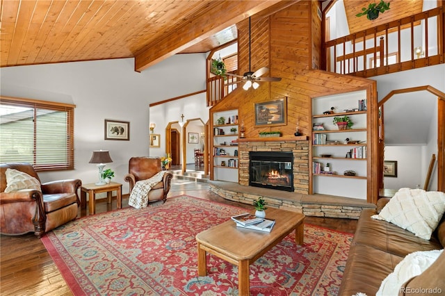 4515 Red Rock Dr, Larkspur, CO 80118 - living area featuring ceiling fan, arched walkways, hardwood / wood-style flooring, high vaulted ceiling, and a stone fireplace