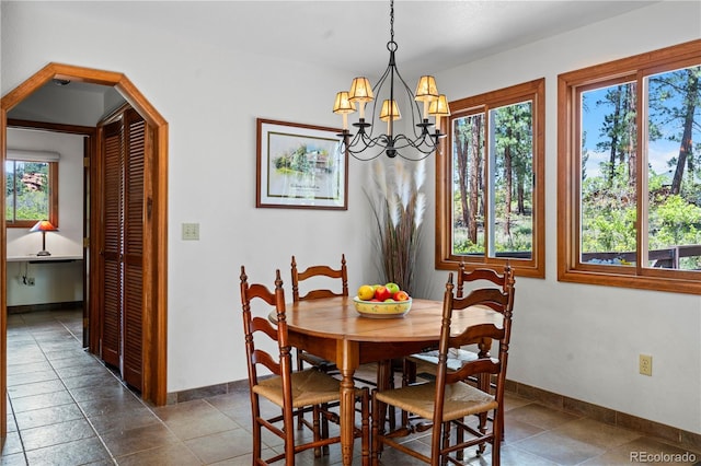 4515 Red Rock Dr, Larkspur, CO 80118 - dining room with plenty of natural light, baseboards, and a chandelier