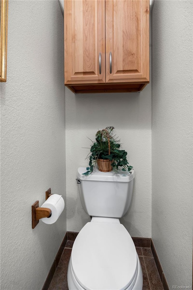 4515 Red Rock Dr, Larkspur, CO 80118 - bathroom featuring toilet, baseboards, and tile patterned flooring