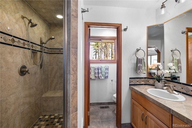 4515 Red Rock Dr, Larkspur, CO 80118 - full bath featuring a shower stall, vanity, toilet, and decorative backsplash