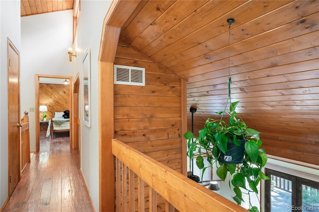 4515 Red Rock Dr, Larkspur, CO 80118 - corridor featuring lofted ceiling, wooden ceiling, hardwood / wood-style floors, wood walls, and an upstairs landing