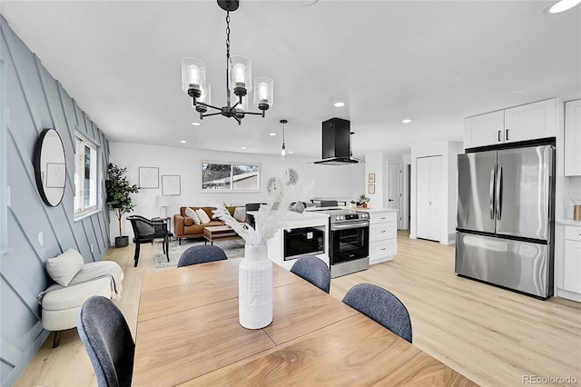 dining room featuring a notable chandelier and light hardwood / wood-style flooring