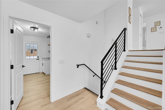 stairs featuring hardwood / wood-style flooring