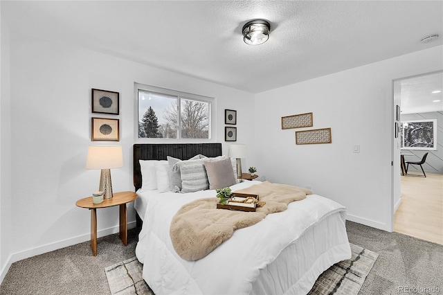 carpeted bedroom featuring a textured ceiling