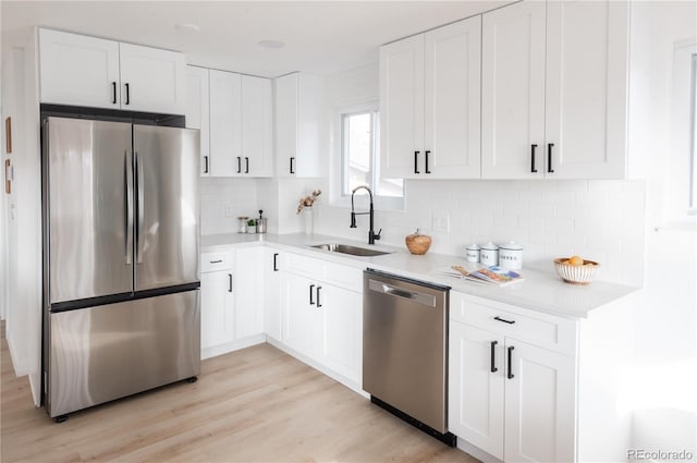 kitchen with white cabinetry, sink, and stainless steel appliances