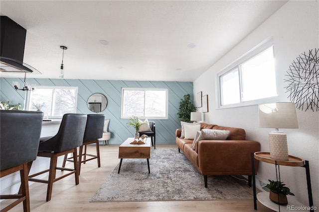 living room with a wealth of natural light and light hardwood / wood-style flooring