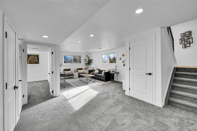 living room featuring carpet flooring and a textured ceiling