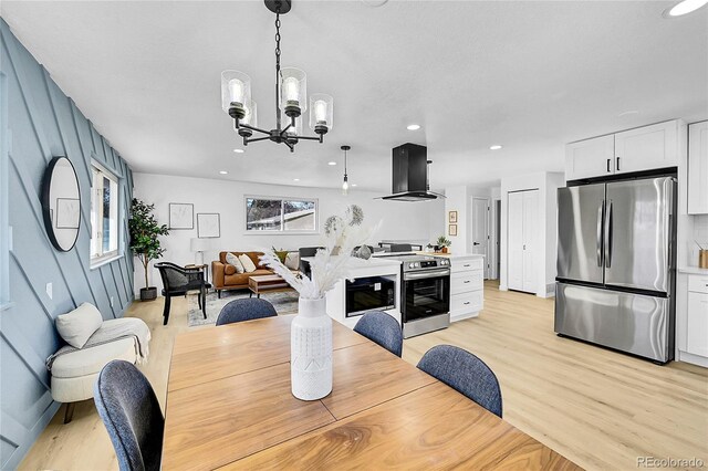 dining area featuring a notable chandelier, plenty of natural light, and light hardwood / wood-style floors