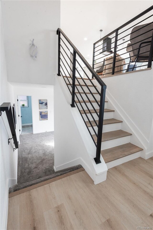 stairway featuring wood-type flooring