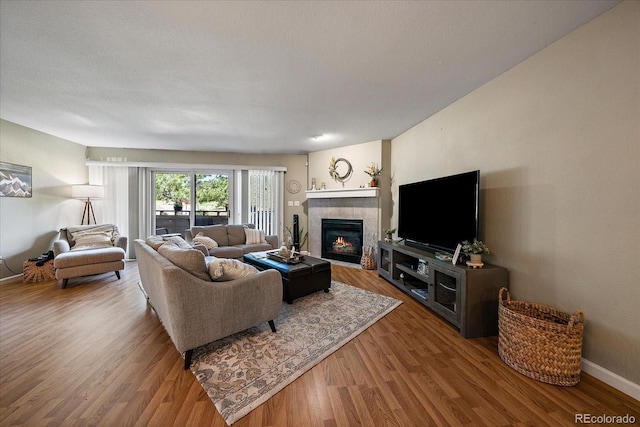 23712 Pondview Pl Unit A, Golden, CO 80401 - living area featuring wood finished floors and a tiled fireplace