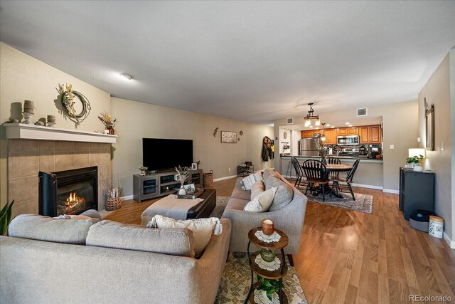 23712 Pondview Pl Unit A, Golden, CO 80401 - living area with wood finished floors and a tile fireplace
